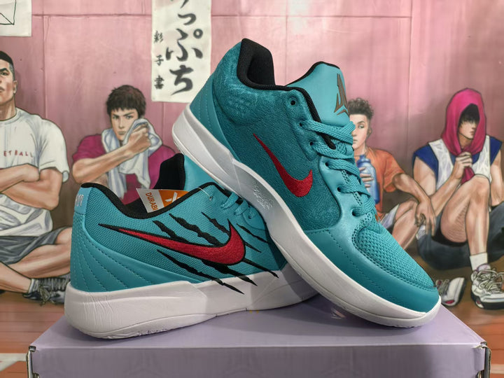 Pair of teal Jordan basketball sneakers with red and black side graphics displayed on a shoebox.