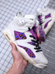 Close three-quarter view of the sneaker with purple tongue detailing, patterned side panels, and additional laces.
