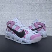 Three-quarter view of the pair highlighting the white and pink design.