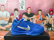 Side view of a blue Nike Kobe shoe with white Swoosh and red stitching