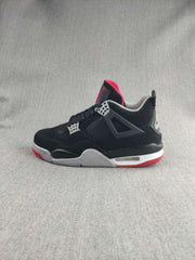 Side profile highlighting the black upper, mesh panel, gray midsole, and red outsole.
