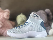 Side profile showing patterned panels and a white sole on a high-top basketball shoe