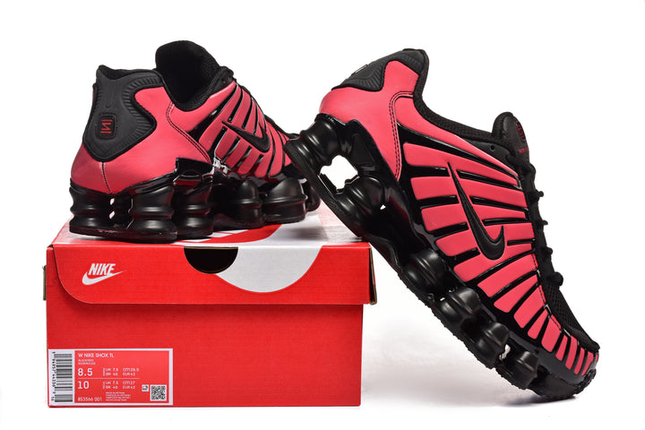 Black and pink Nike Shox TL-style sneakers shown with a box; box label visible.