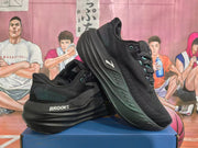 Black Brooks shoes arranged at an angle, showing the side and sole details.
