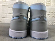 Rear view of the pair showing the gray heel panels, pale blue collar accents, midsoles, and outsole edges.