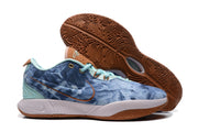 Side and outsole view of the sneakers, highlighting the textured gum-colored tread and blue mottled upper.