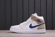 Lateral side view highlighting the perforated toe, dark blue Swoosh, tan ankle panel, and white outsole.