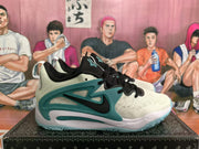 Side view of a cream and teal Nike sneaker showing the black Swoosh and layered teal side structure.