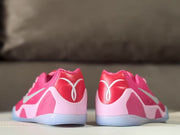 Rear view showing the pink heel panels, white heel details, and translucent outsoles.
