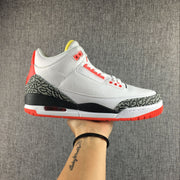 Side view of a white Jordan 3 sneaker with elephant-print overlays and red accents.