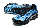 Angled view of the blue patterned Nike Air Max Plus VII sneakers with black laces and metallic-tone side Swoosh.