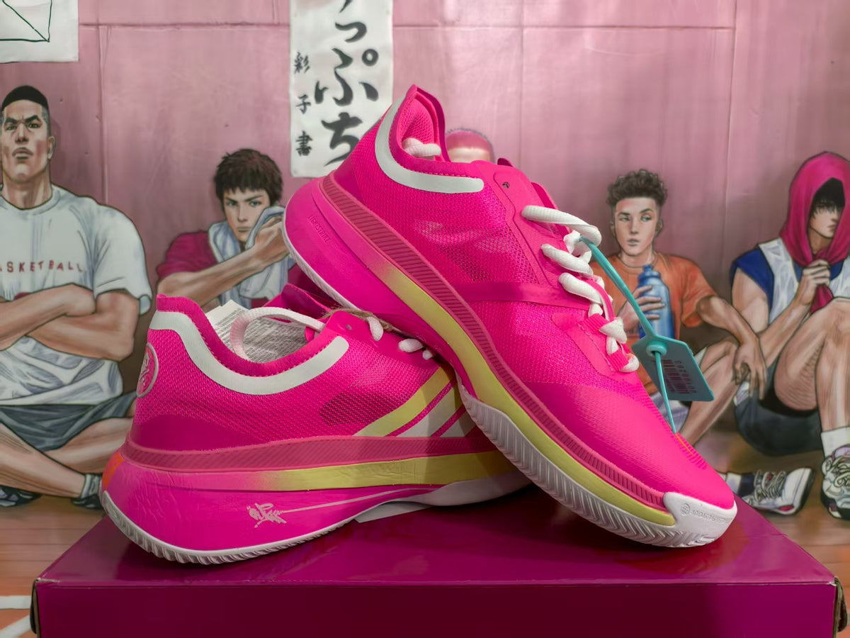 Pair of bright pink basketball sneakers shown from an angled side view on a box.