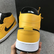 Rear view showing the yellow padded collar, black lining, and white midsole.