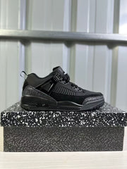 Black Jordan Spizike Low sneaker shown in side profile on a patterned shoebox.