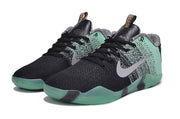 Pair of mint green and black low-cut basketball shoes, front three-quarter view