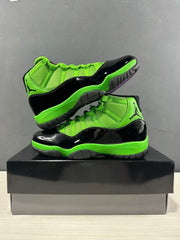 Pair of black and green high-top sneakers arranged diagonally on a black box.