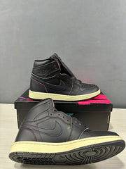 Close side view of the black high-top sneakers showing the tonal Swoosh, ankle emblem and light-colored midsole.