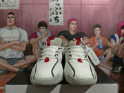 Front view of a pair of white Nike basketball shoes with red lace details and perforated uppers