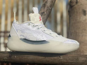 Side profile of a white Jordan 39 sneaker showing the patterned upper and translucent outsole