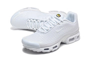 Angled view of white Nike Air Max Plus VI sneakers with textured uppers and visible sole windows.