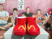 Front view of the red basketball sneakers showing red laces, gold graphics, and matching red outsoles.