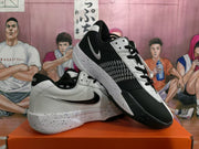 Angled view of the pair of white and black Nike basketball sneakers displayed together, showing the Swoosh and textured side panels.