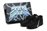 Pair of black sneakers displayed beside a black-and-blue lightning graphic shoebox.
