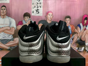 Rear view showing silver textured heel panels, black collars, and visible Swoosh details.