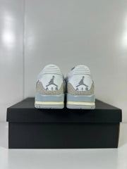 Rear view of the pair showing Jordan heel branding, silver patterned heel panels, and layered midsoles.