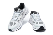 Front views of a pair of white and grey lace-up sneakers.