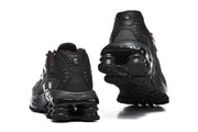 Rear and outsole views of black Nike Shox Ride 2 sneakers with spring-shaped heel elements.