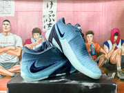 Angled view of gray-blue Nike basketball shoes with dark blue accents