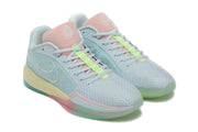 Angled close view of the pair highlighting the pastel blue uppers, pink tongues, and lime green lace details.