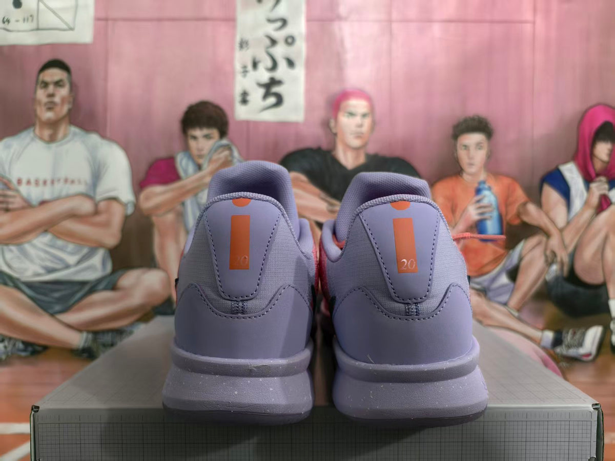 Rear view of lavender Nike basketball shoes with coral heel details.