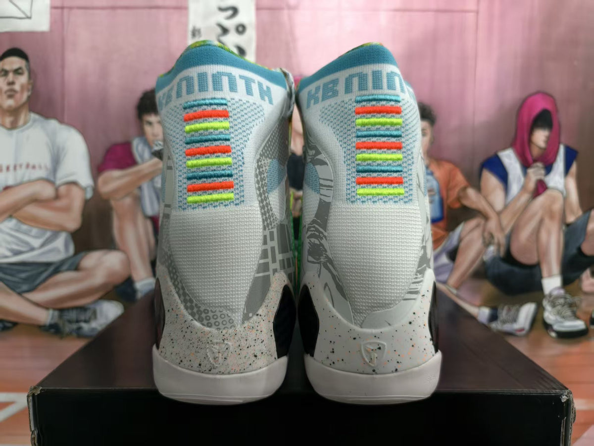 Rear view of the mismatched high-top sneakers showing gray uppers, multicolor heel accents, patterned panels, and white soles.