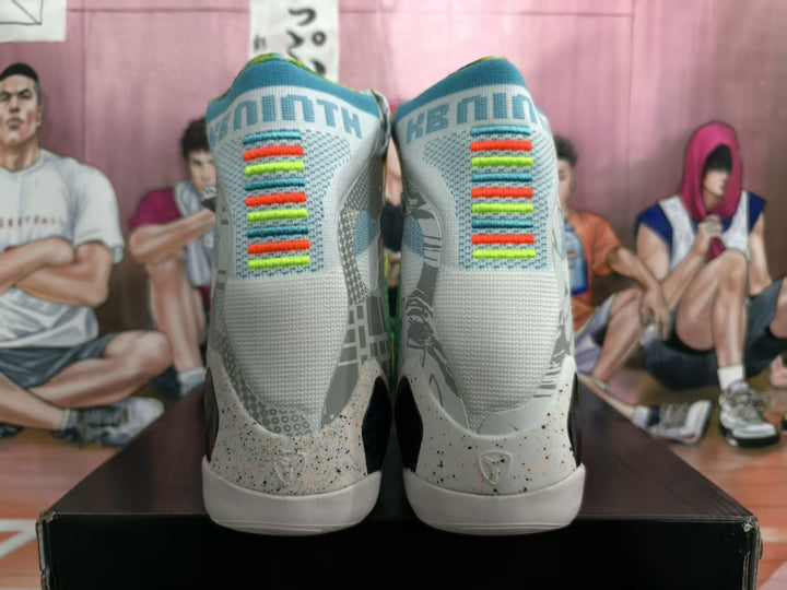 Rear view of the mismatched high-top sneakers showing gray uppers, multicolor heel accents, patterned panels, and white soles.