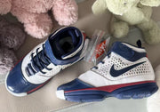 Angled top view showing the padded navy collars, laces, ankle straps, and patterned side panels.