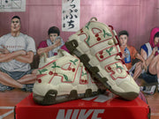 Angled view of cream Nike sneakers with cherry graphics and oversized side lettering