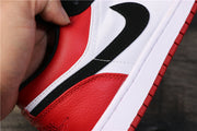 Close-up of the sneaker's black Swoosh and red and white side panels.