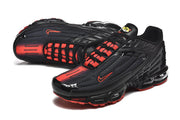 Pair of black Nike Air Max Plus III sneakers with red lace details and red accents.