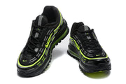 Front and top views of black Nike Air Max sneakers with volt accents