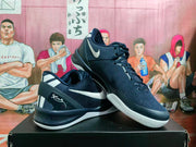 Angled view of the navy blue sneaker pair showing the white Swoosh, laces, heel details, and outsole tread.