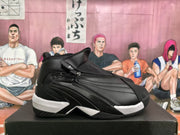 Side profile showing the black layered upper, side zipper, raised collar, and contrasting white-and-black sole.