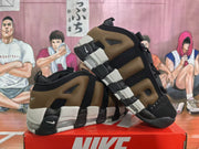 Side view showing the layered brown and black upper, light midsole sections, and heel cushioning details.