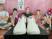 Front view of white Nike Kobe basketball shoes with logo details on the tongues.