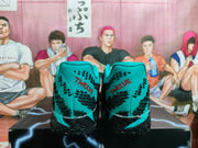 Rear view of teal Nike shoes with black patterning and red heel lettering.