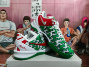 Pair of green, white, and red Nike-style basketball sneakers displayed on a shoebox.