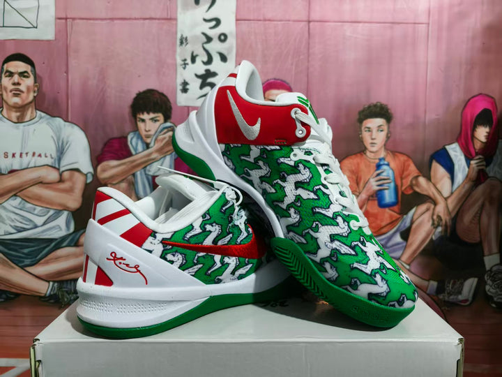 Pair of green, white, and red Nike-style basketball sneakers displayed on a shoebox.