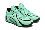 Three-quarter view of the green and black Jordan sneakers showing the side logos, perforated panels, and translucent side cushioning panels.