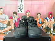 Front view of black basketball shoes with black laces and textured uppers.